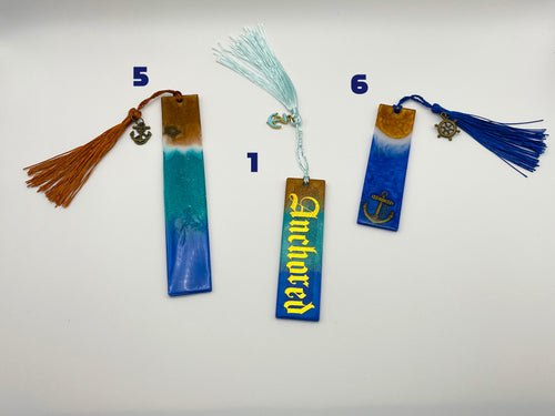 Three bookmarks with tassels on a white background